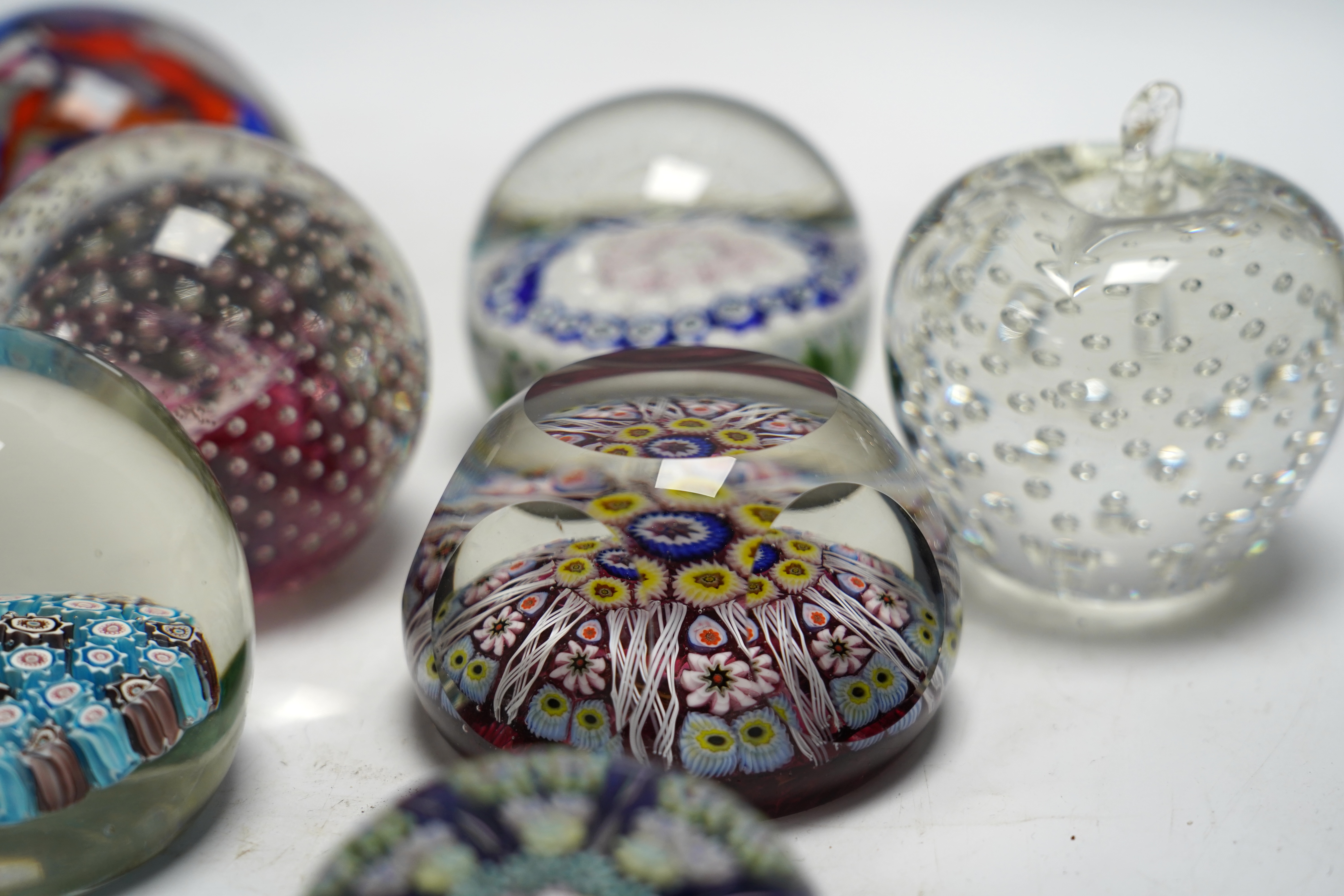 Eleven mixed Scottish and other glass paperweights including Caithness, largest 8.5cm in diameter